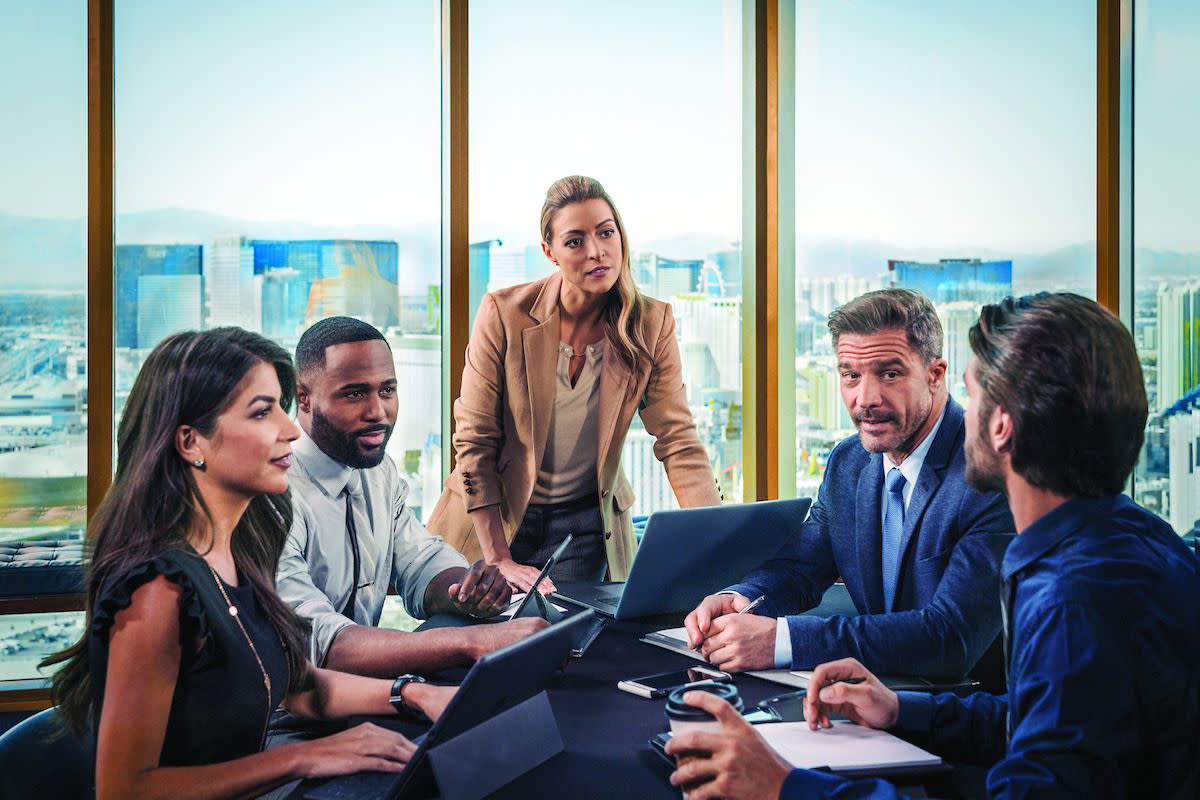 A group of business individuals at a work meeting.