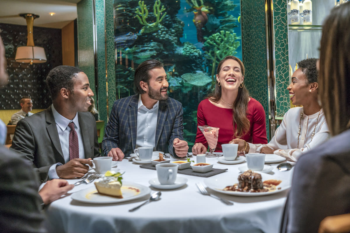 A group of professionals enjoying themselves at a business dinner.